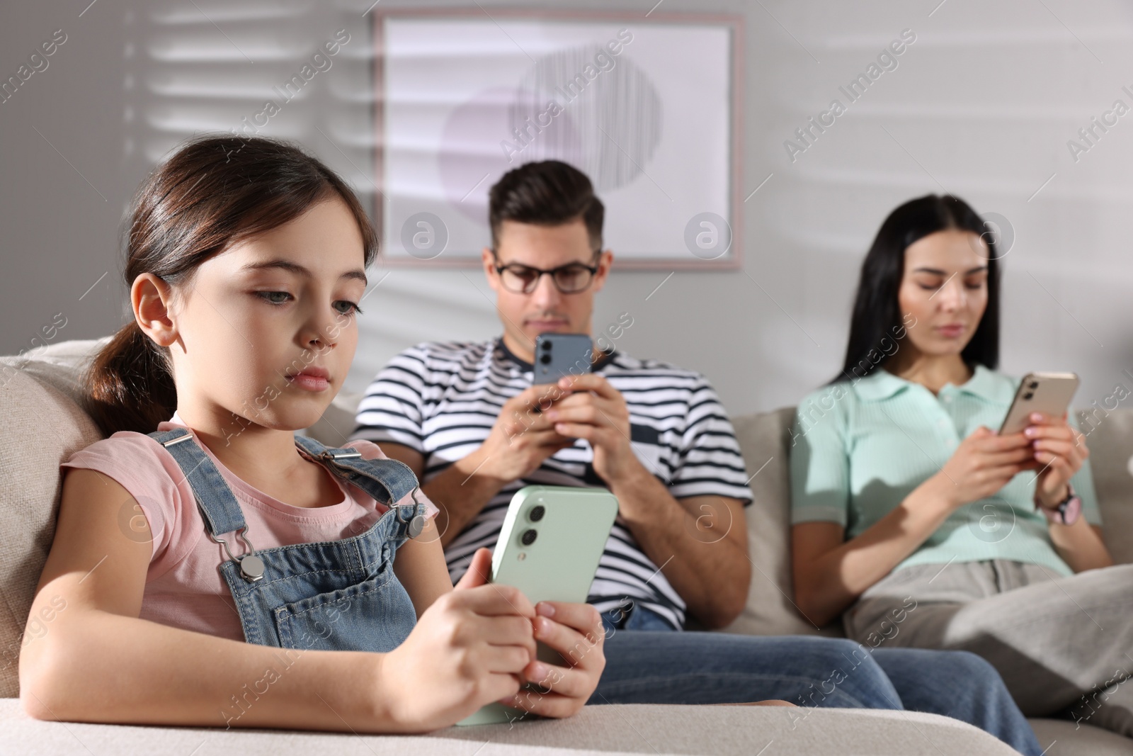 Photo of Internet addiction. Family with different gadgets on sofa at home