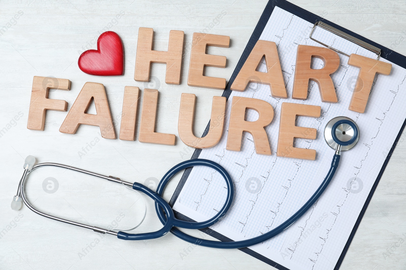 Photo of Text Heart Failure with stethoscope and cardiogram on light background, flat lay