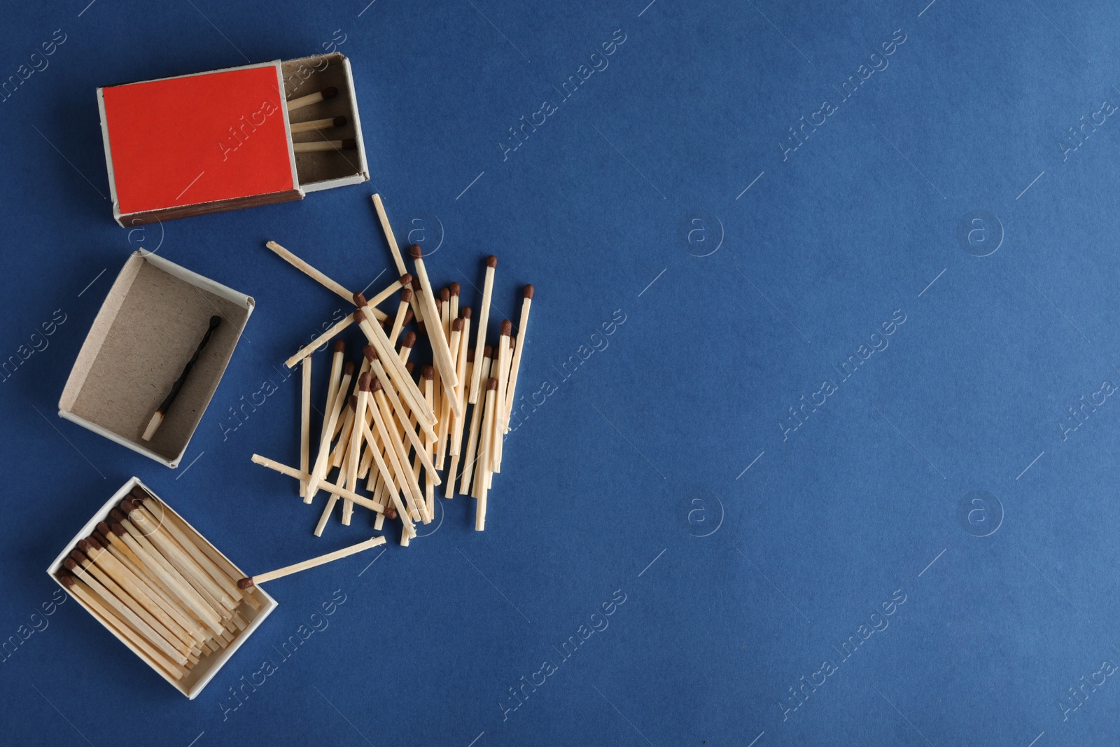 Photo of Flat lay composition with matches and space for text on color background