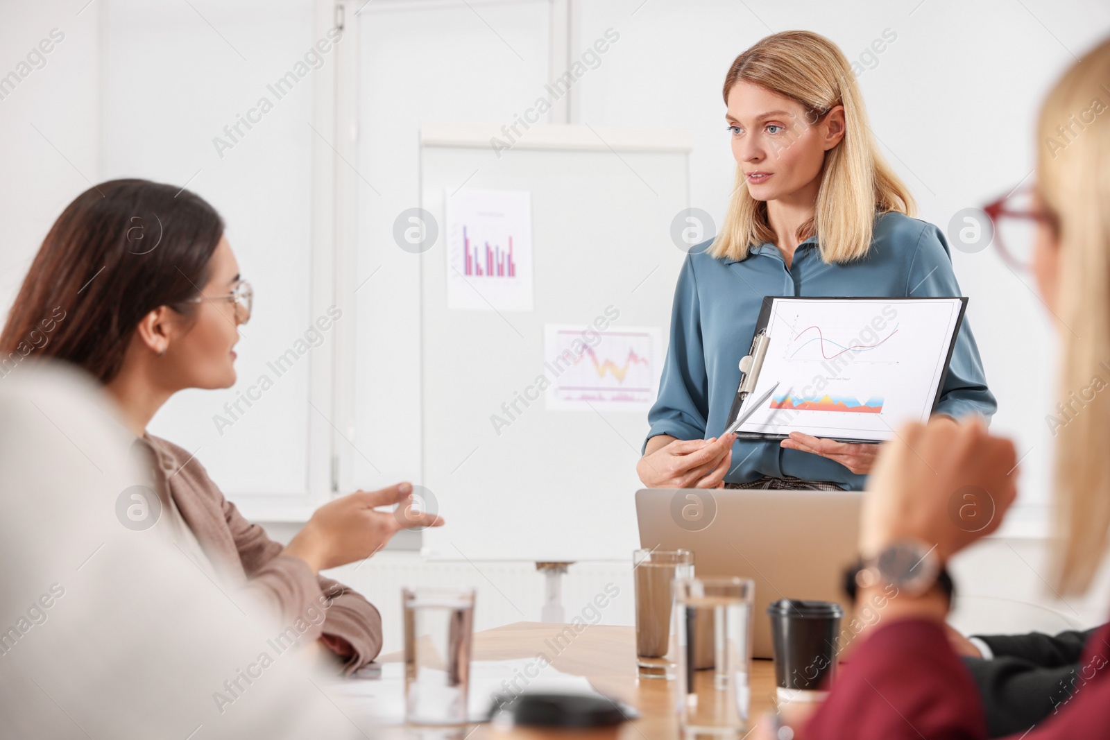 Photo of Businesswoman showing chart on meeting in office