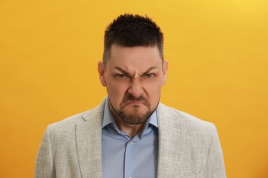 Angry man on yellow background. Hate concept
