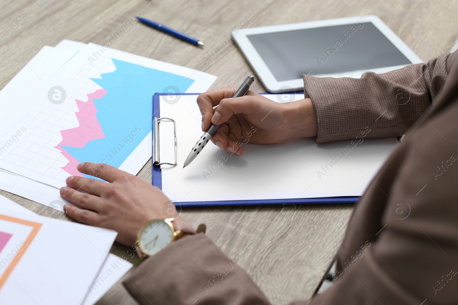 Photo of Businesswoman working with documents at office table, closeup