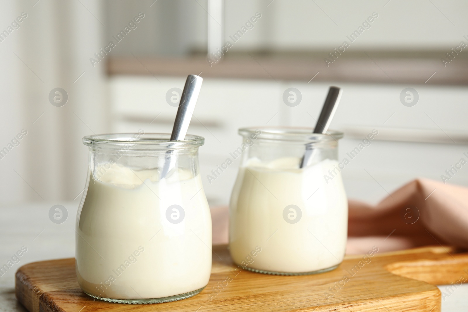 Photo of Tasty organic yogurt on wooden board indoors