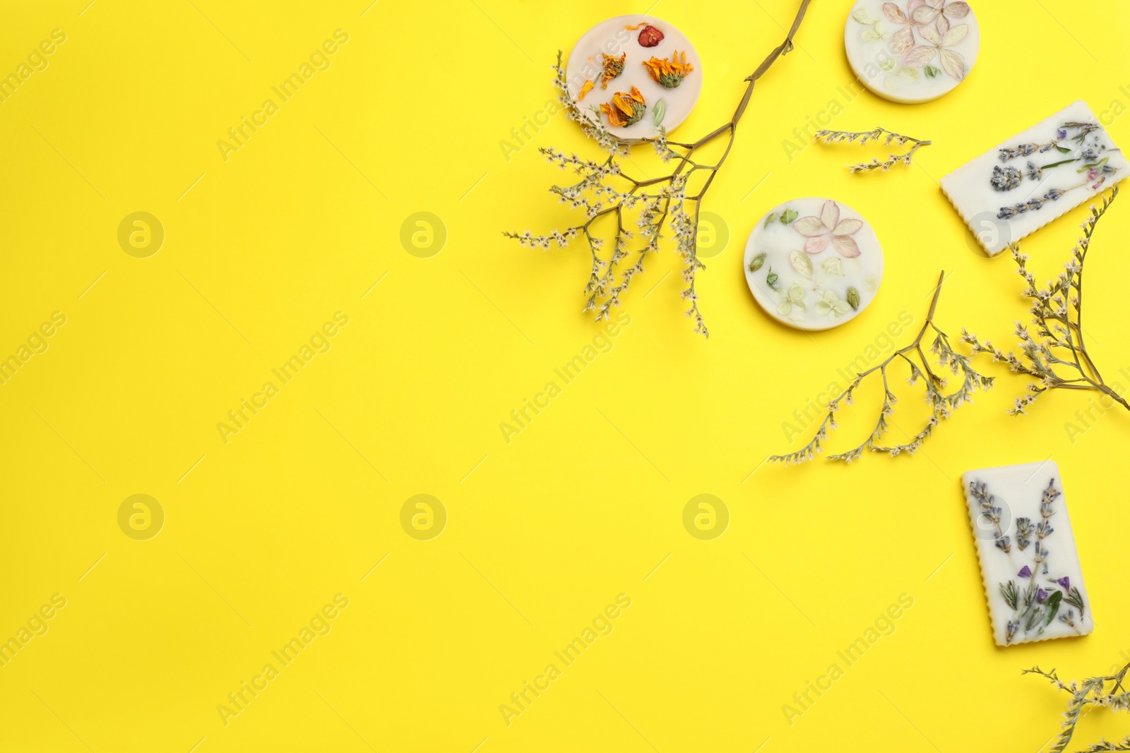 Photo of Flat lay composition with scented sachets on yellow background, space for text