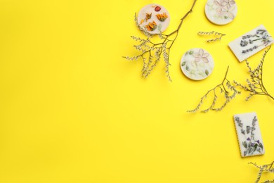 Photo of Flat lay composition with scented sachets on yellow background, space for text