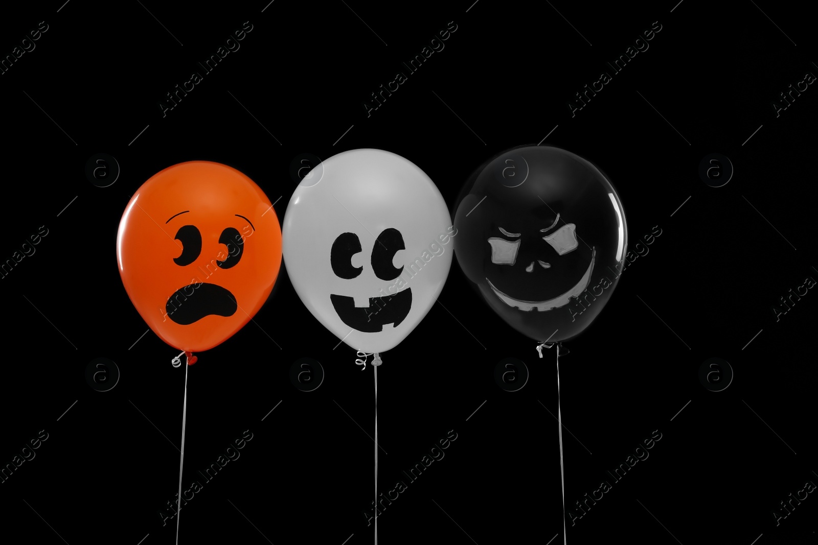 Photo of Spooky balloons for Halloween party on black background