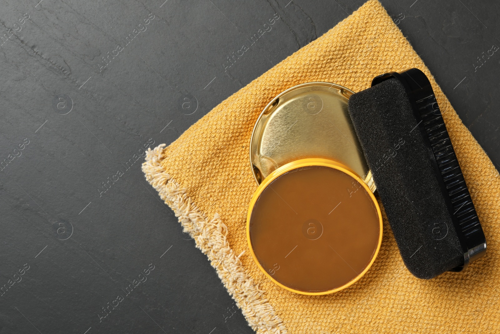 Photo of Shoe care accessories on black background, top view