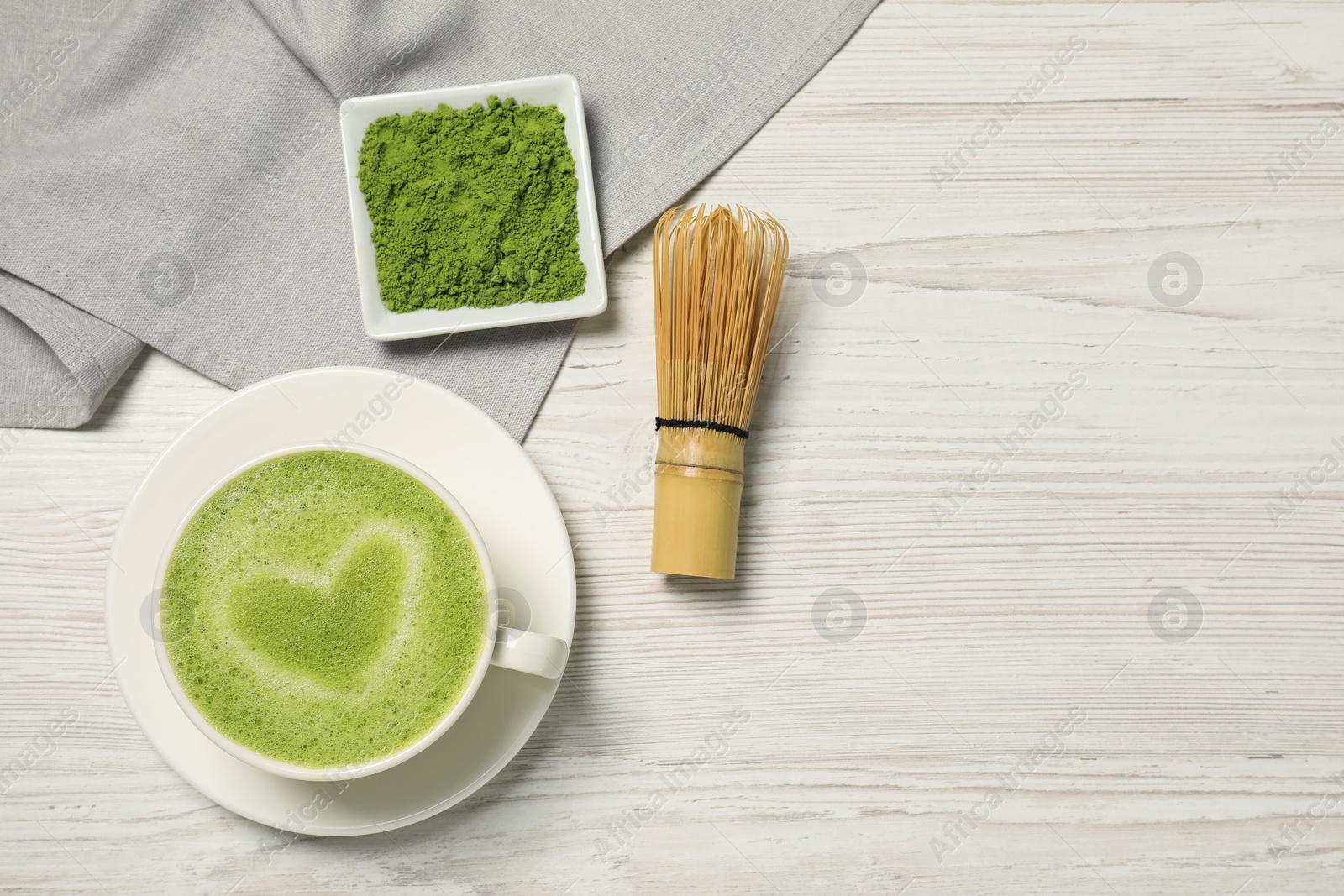 Photo of Flat lay composition with tasty matcha latte on white wooden table, space for text