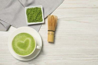 Flat lay composition with tasty matcha latte on white wooden table, space for text
