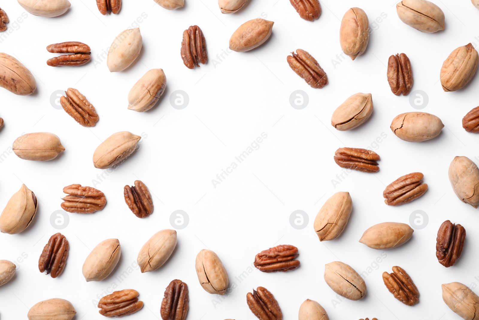 Photo of Frame made of pecan nuts on white background, top view with space for text