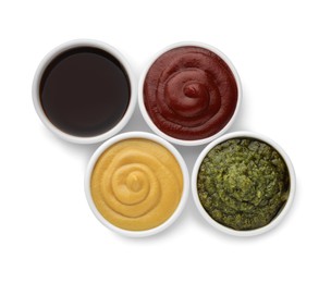 Photo of Many different sauces in bowls on white background, top view