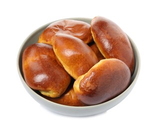 Photo of Bowl with delicious baked pirozhki on white background