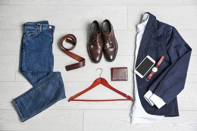 Photo of Male clothes, footwear and accessories on wooden background