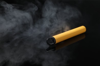 Electronic cigarette and smoke on black background, space for text