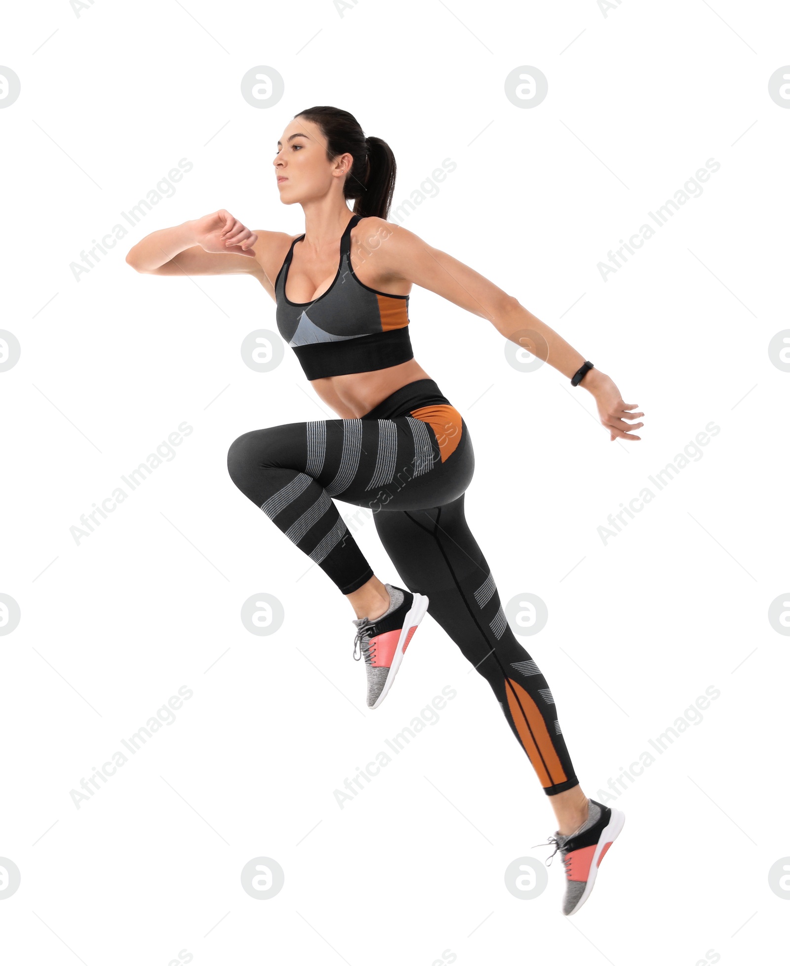 Photo of Athletic young woman running on white background, side view