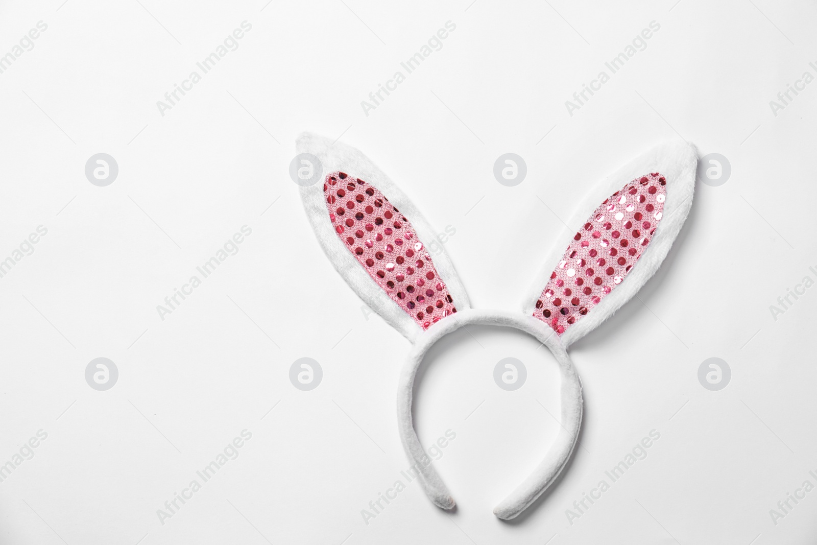 Photo of Funny headband with Easter bunny ears on white background, top view