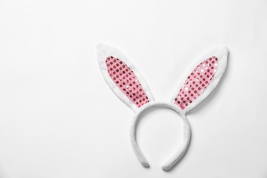 Funny headband with Easter bunny ears on white background, top view