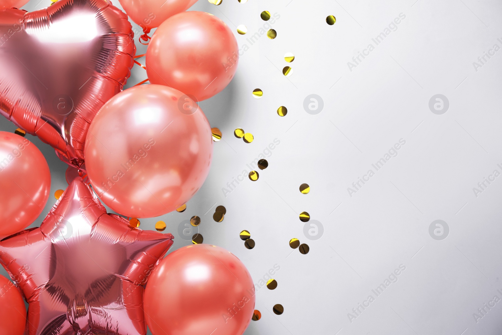 Photo of Festive balloons on white background, flat lay. Space for text