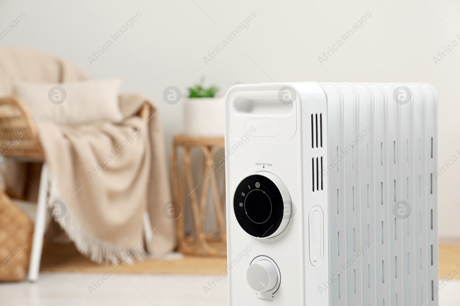 Photo of Modern portable electric heater indoors, closeup. Space for text