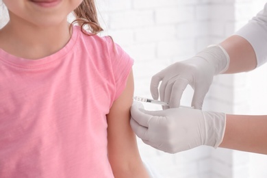 Photo of Doctor vaccinating little girl in hospital