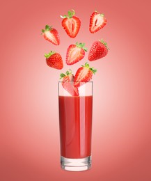 Image of Freshly made strawberry juice on pale red background. Cut and whole berries falling into glass