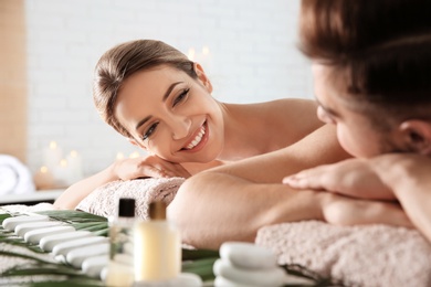 Photo of Romantic young couple relaxing in spa salon