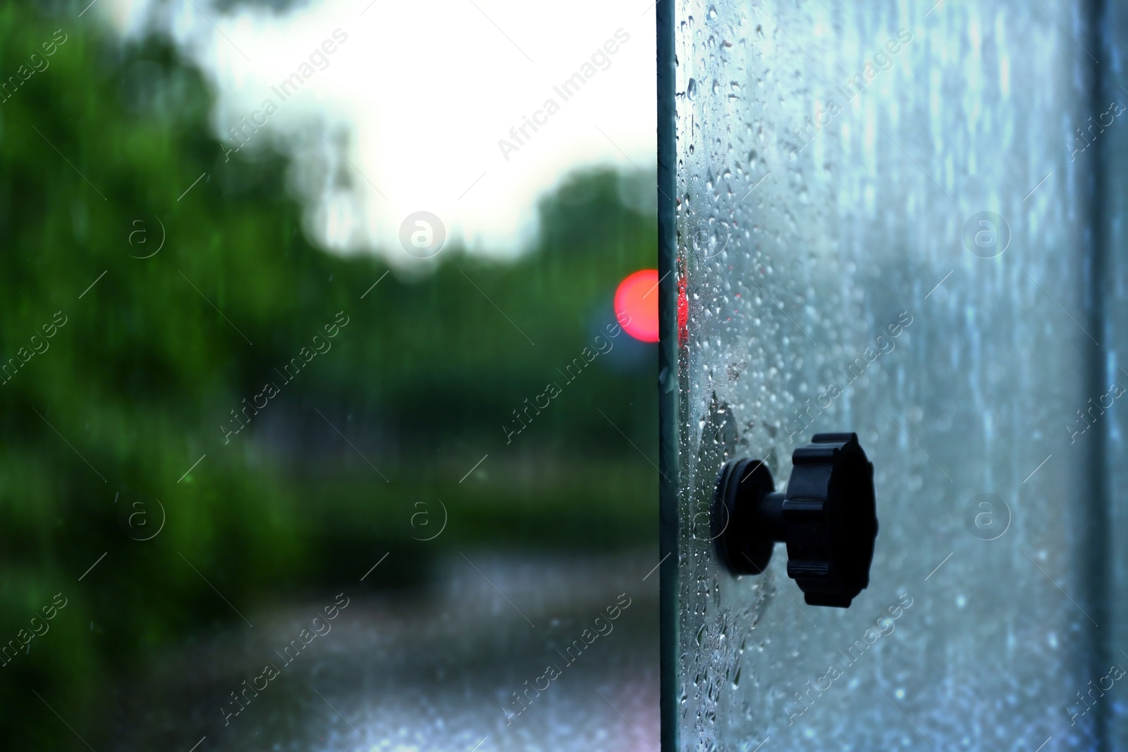 Photo of Open tram window with rain drops, closeup view