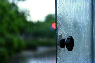 Photo of Open tram window with rain drops, closeup view