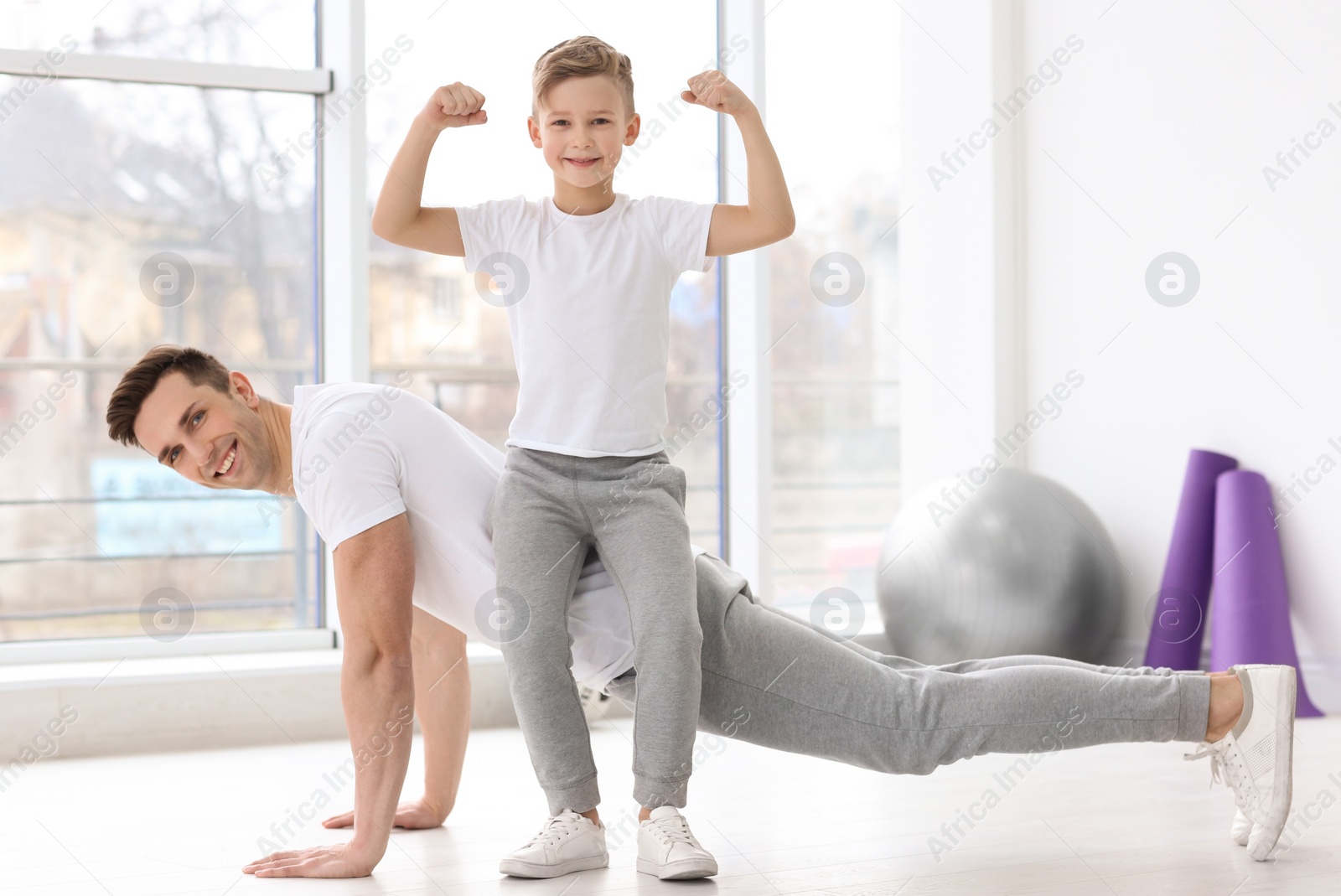 Photo of Dad and his son training in gym