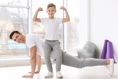 Photo of Dad and his son training in gym