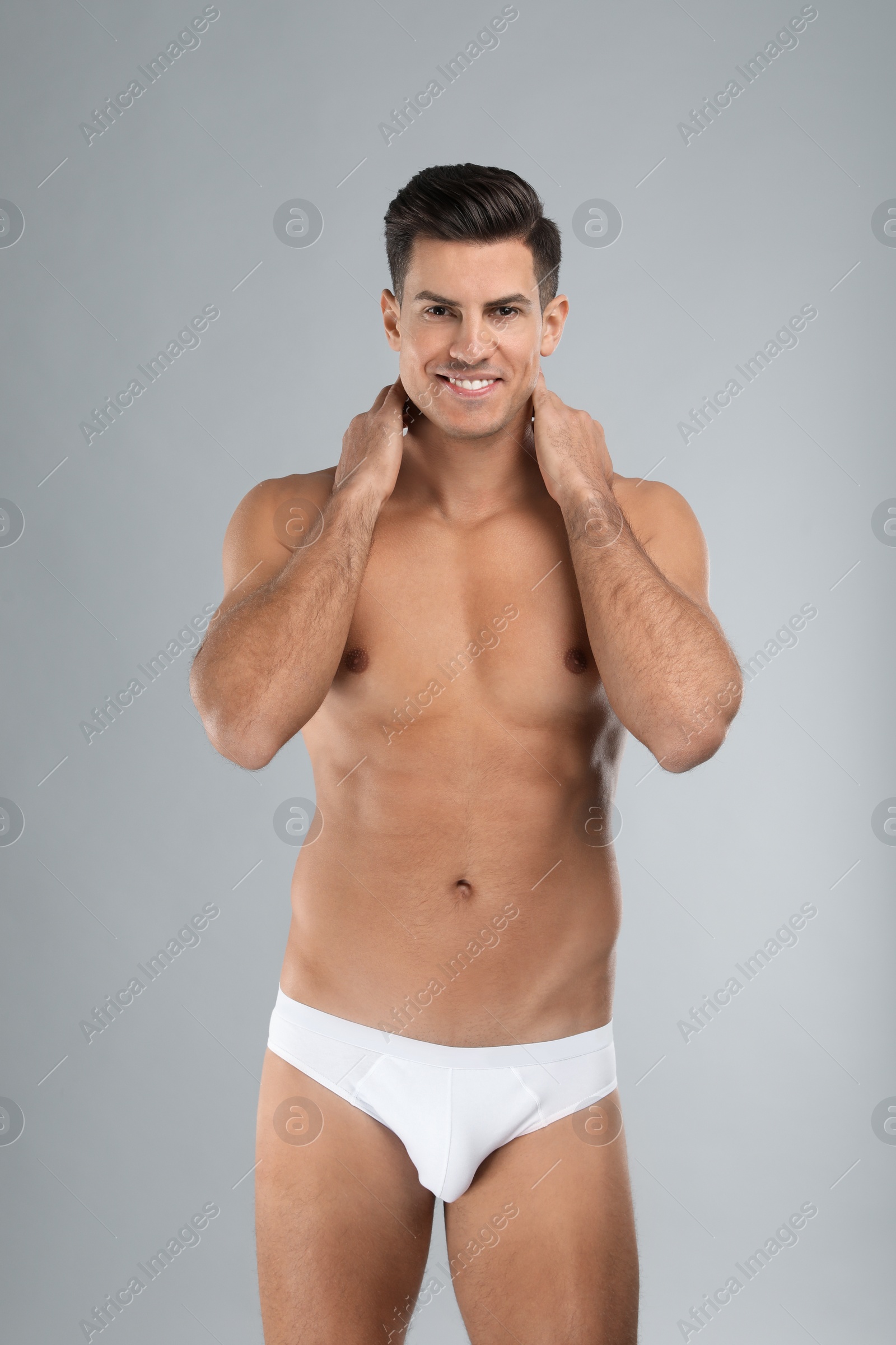 Photo of Handsome man in white underwear on light grey background