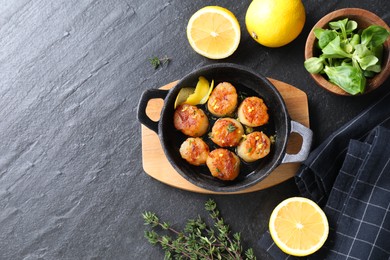 Photo of Delicious fried scallops and ingredients on dark gray textured table, flat lay. Space for text