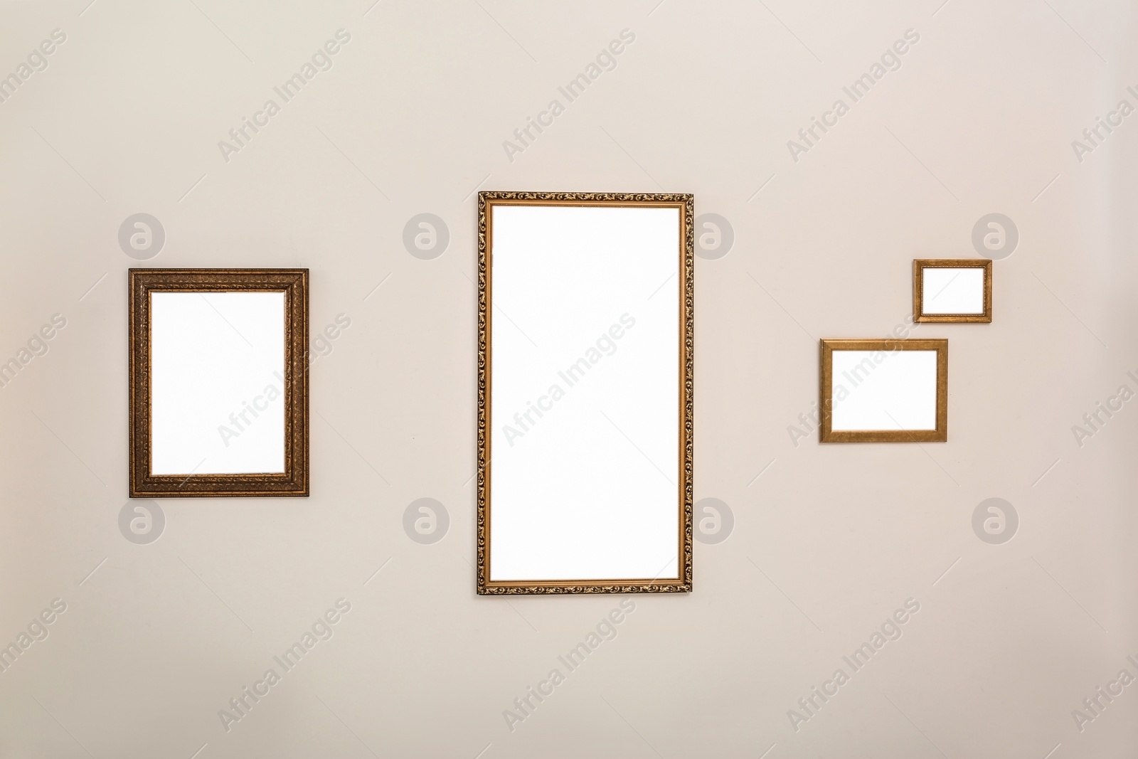 Photo of Frames with empty canvases on wall in modern art gallery. Mockup for design