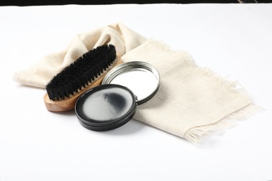 Photo of Shoe care accessories on white background. Footwear clean item