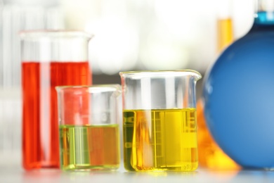 Photo of Glassware with color liquids on table in laboratory