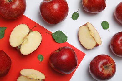 Photo of Flat lay composition with ripe juicy red apples and leaves on color background