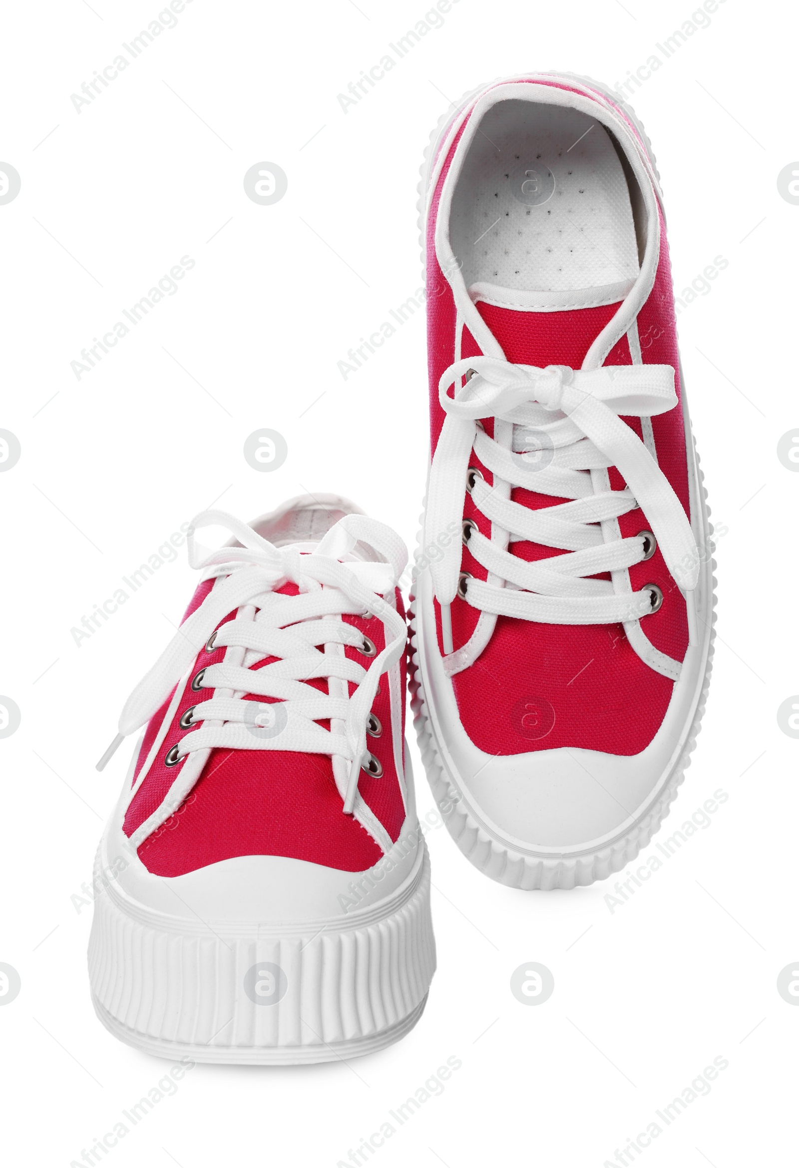 Photo of Pair of red classic old school sneakers on white background