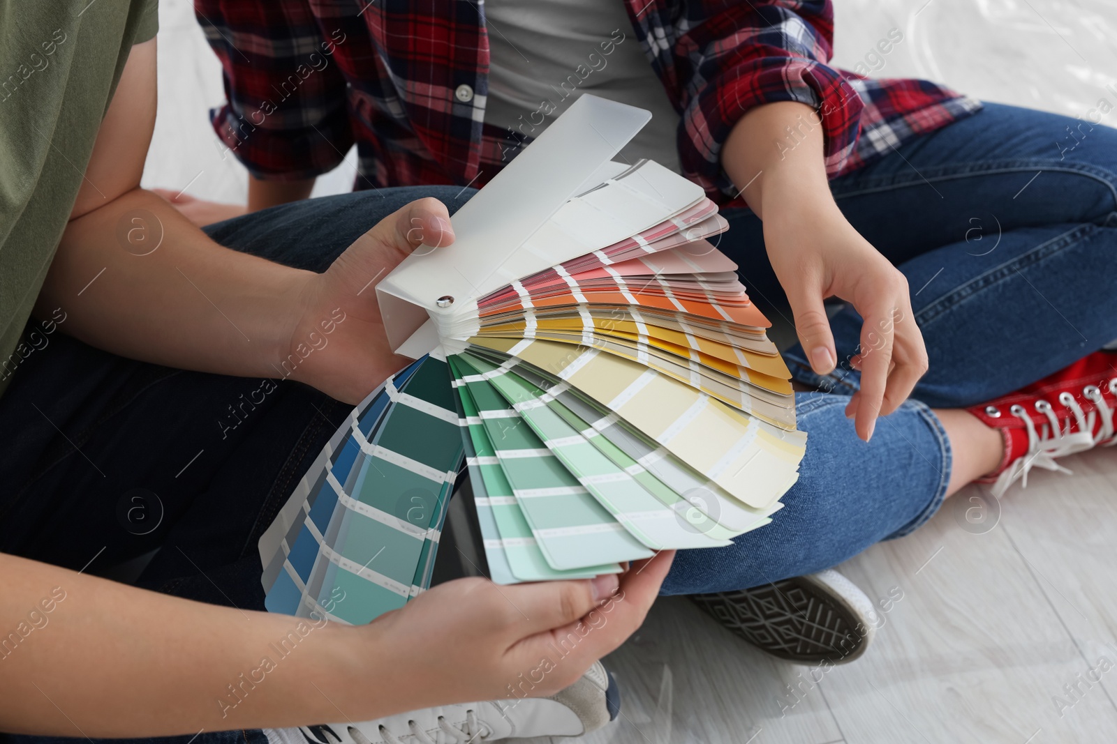 Photo of Couple discussing new wall color in apartment during repair, closeup