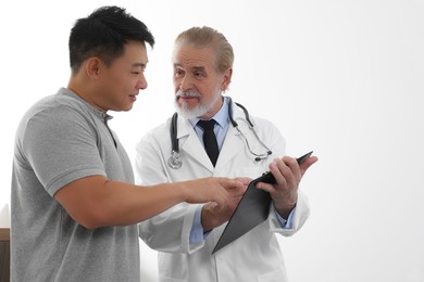 Patient having appointment with doctor on white background