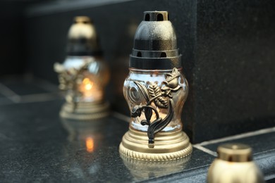 Grave lights on granite surface at cemetery