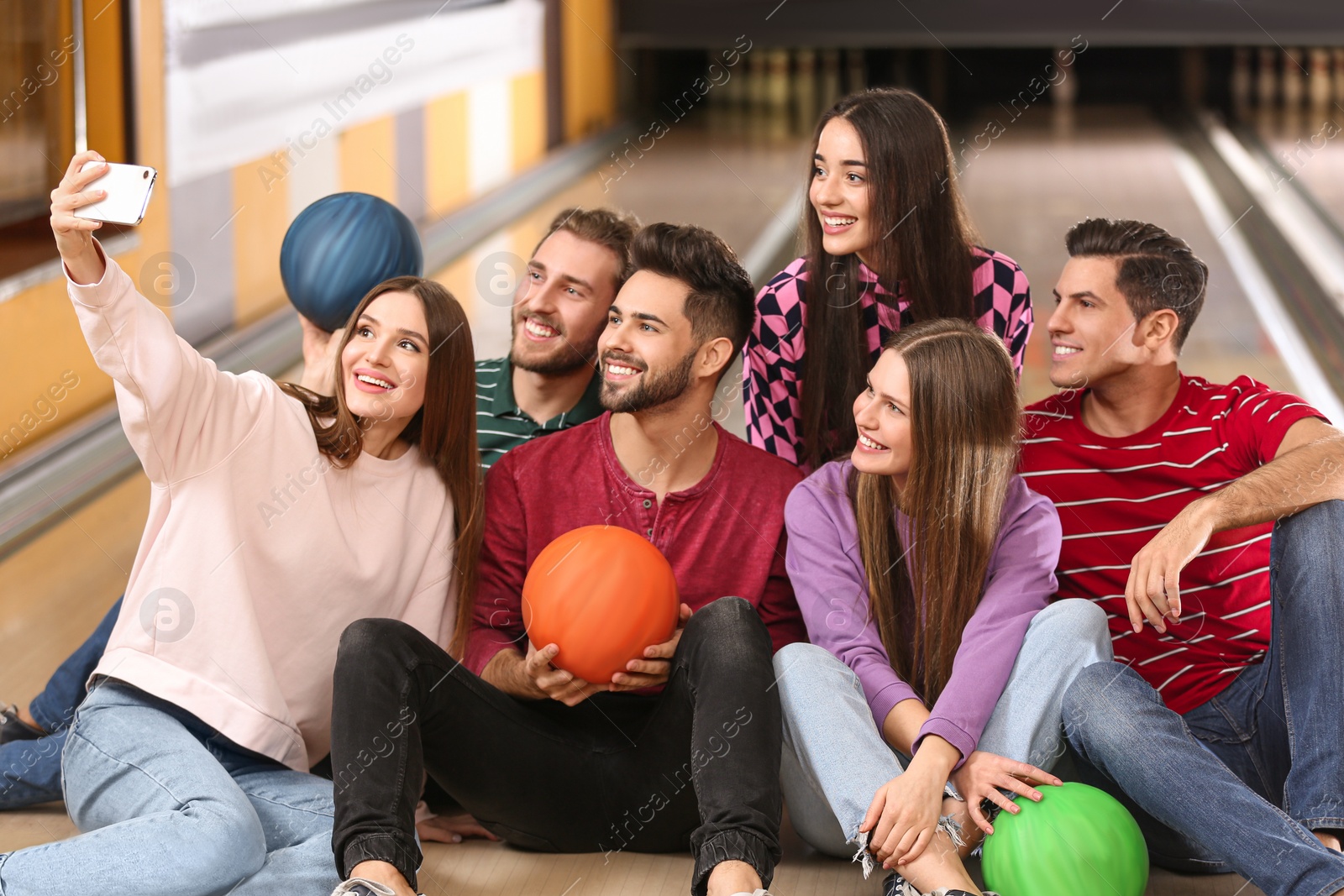 Photo of Group of friends taking selfie in bowling club