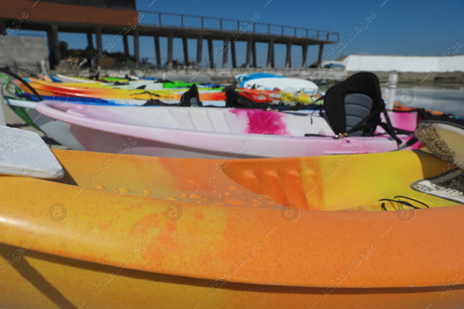 Photo of Many colorful kayaks near sea, closeup view