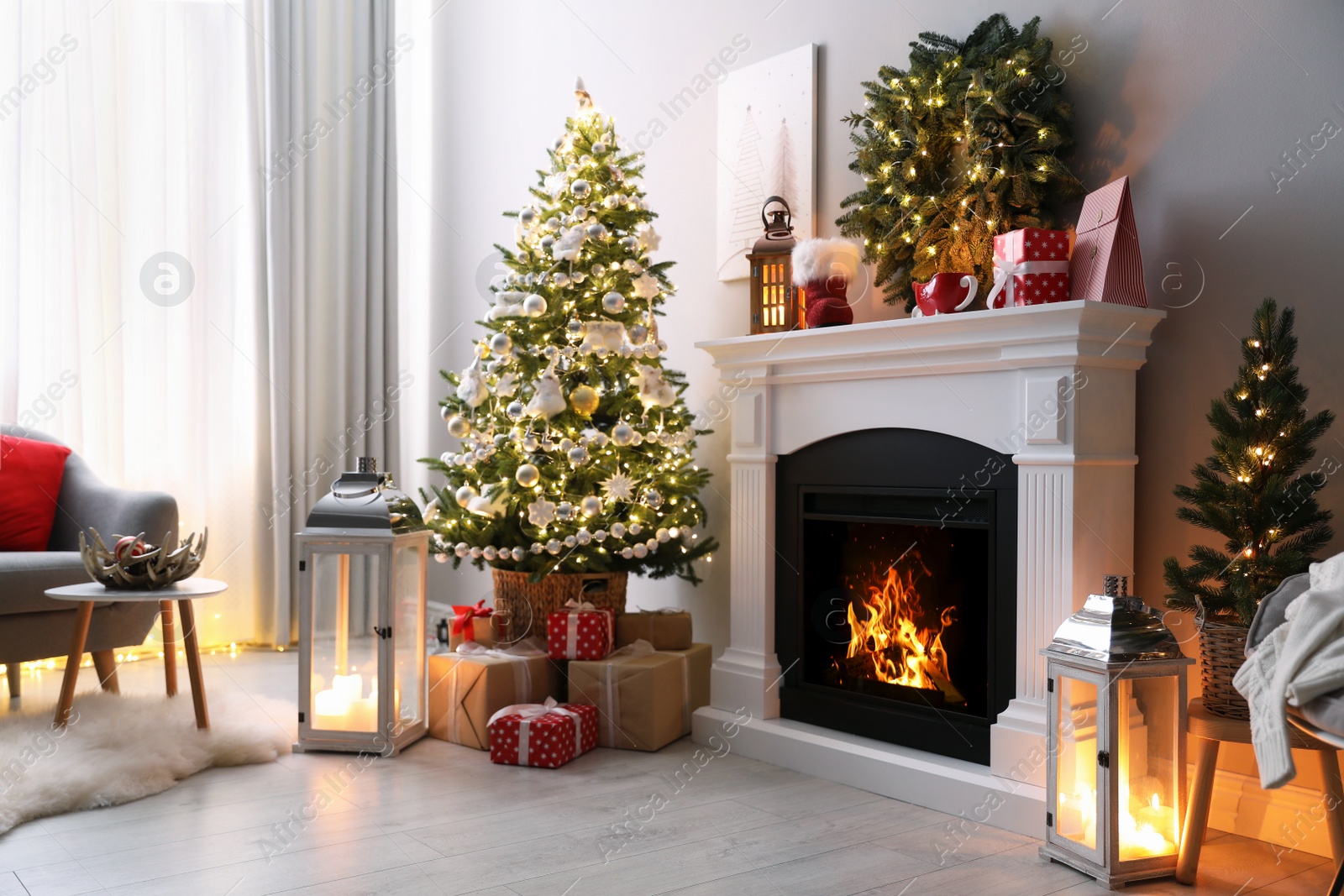 Photo of Stylish living room interior with beautiful fireplace, Christmas tree and other decorations