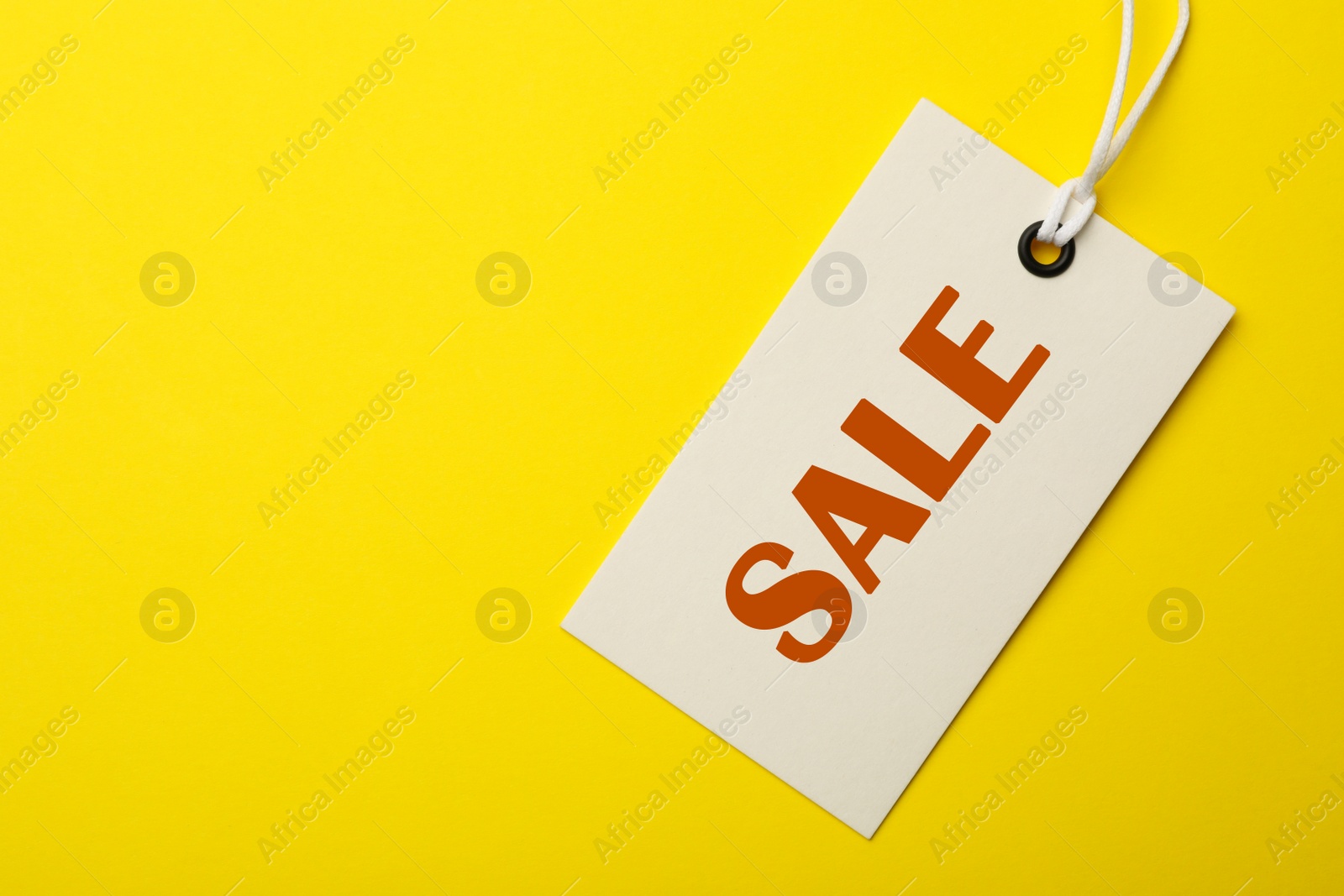 Image of Top view of tag with inscription SALE on yellow background, space for text. Black Friday 