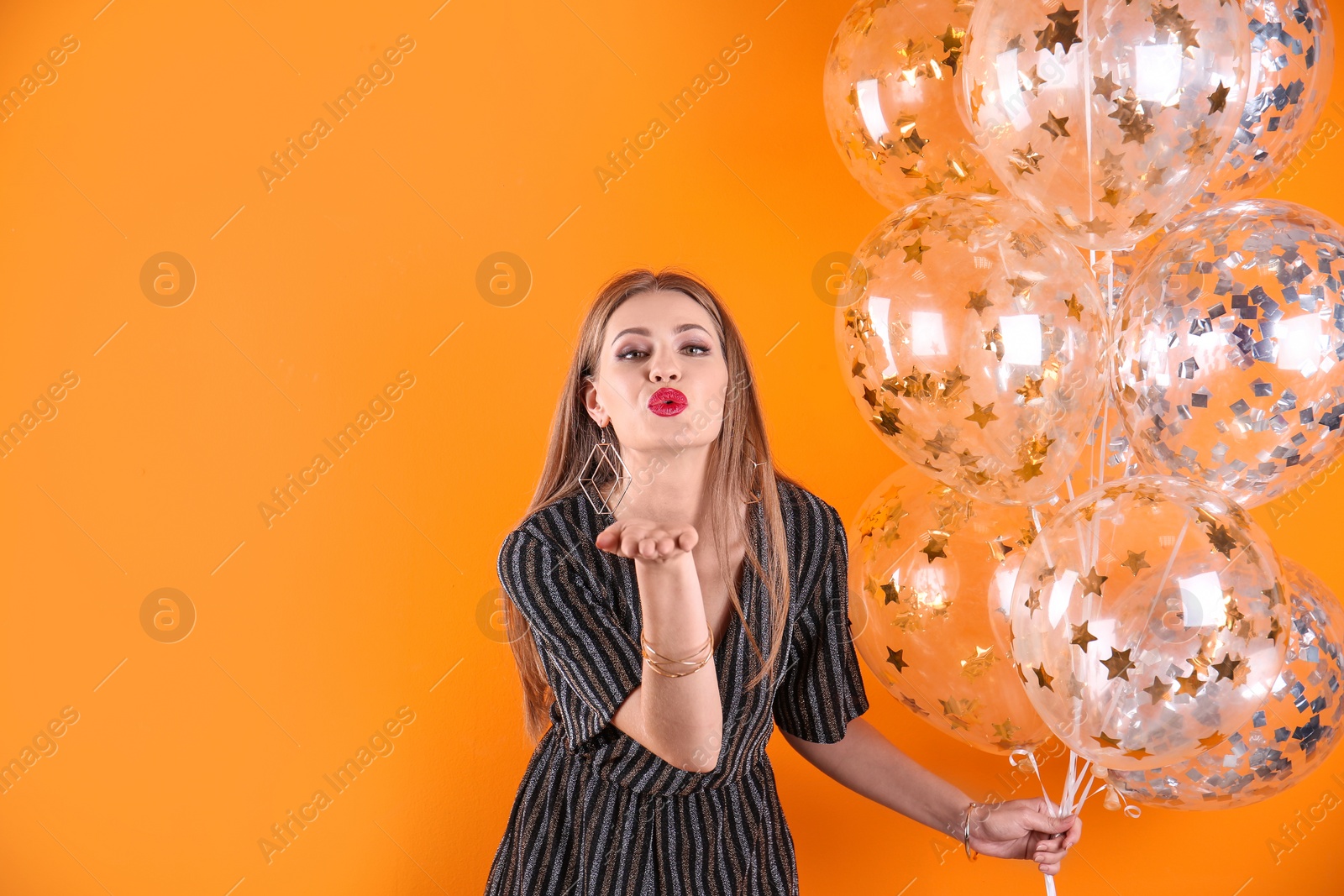 Photo of Young woman with air balloons and space for text on color background