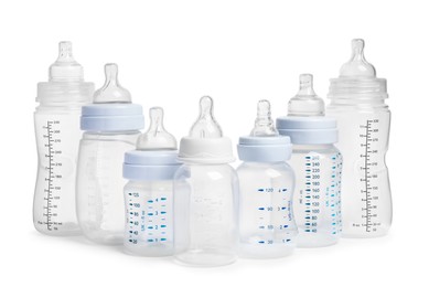Photo of Many different empty feeding bottles for infant formula on white background