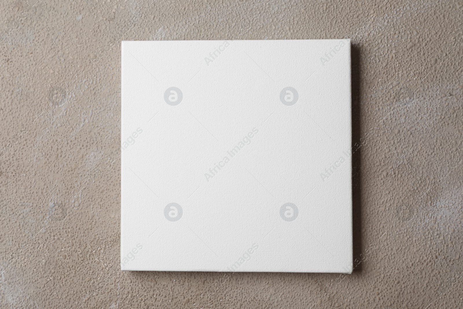 Photo of Blank canvas on brown stone background, space for text