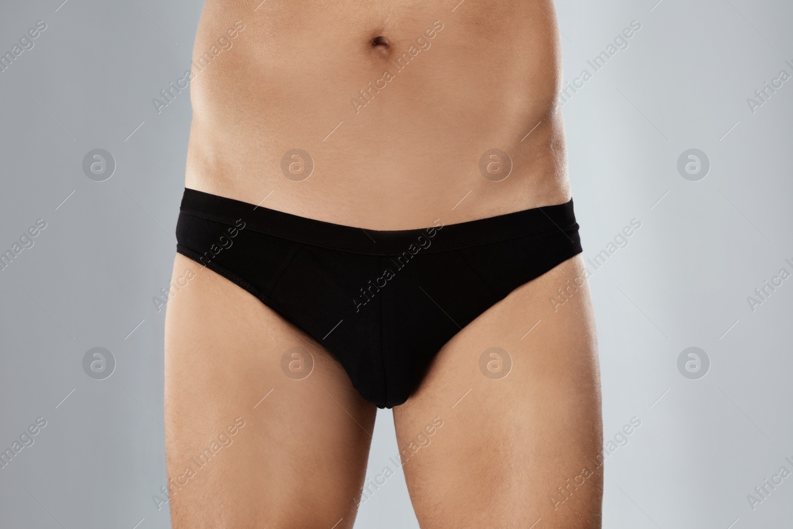 Photo of Man in black underwear on light grey background, closeup