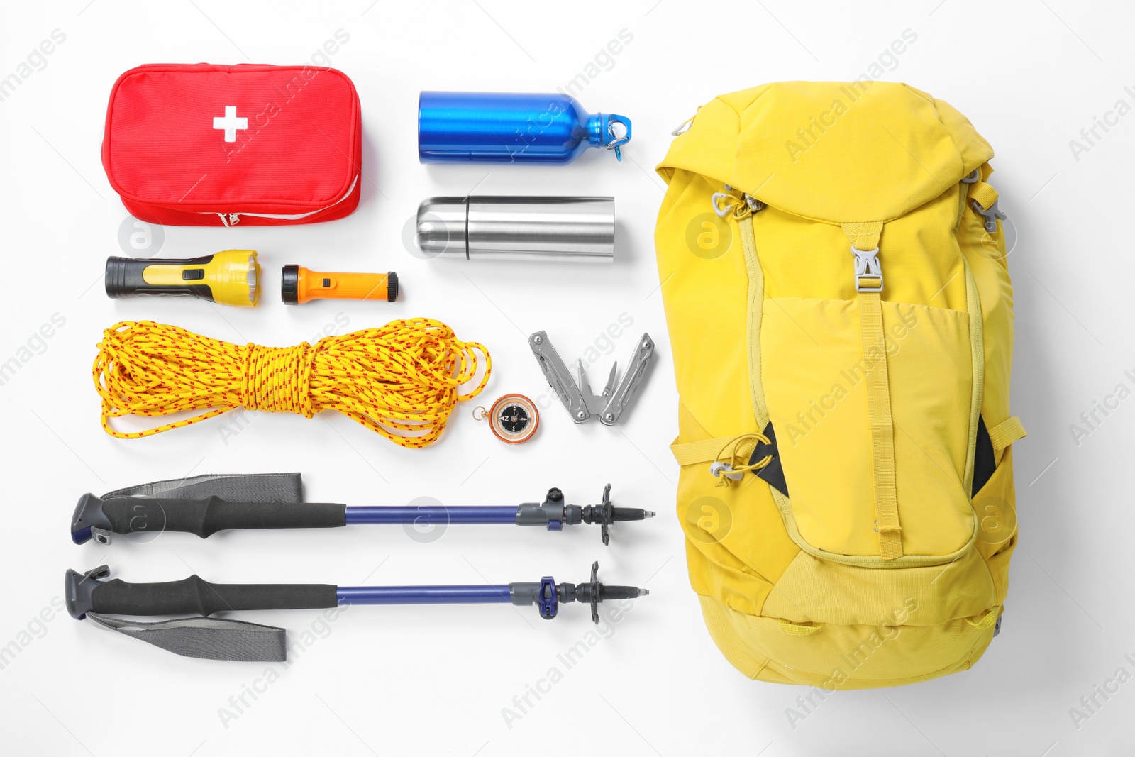 Photo of Trekking poles and other hiking equipment on white background, top view