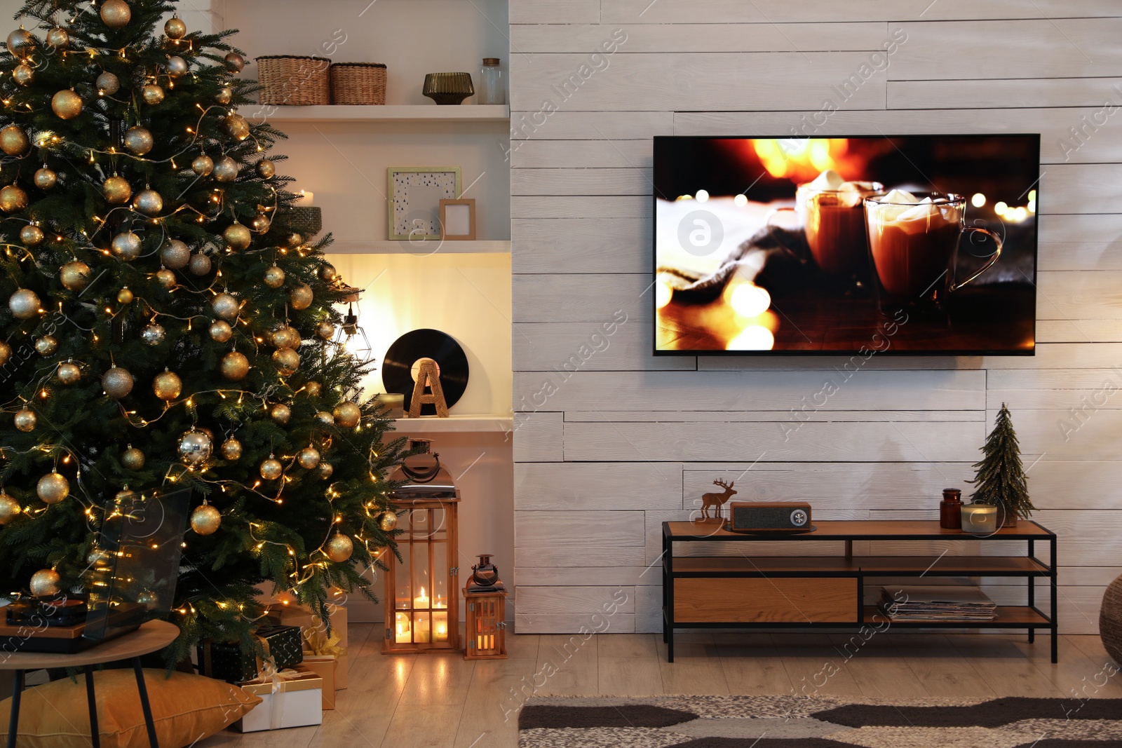 Photo of Plasma TV on white wooden wall in living room beautifully decorated for Christmas